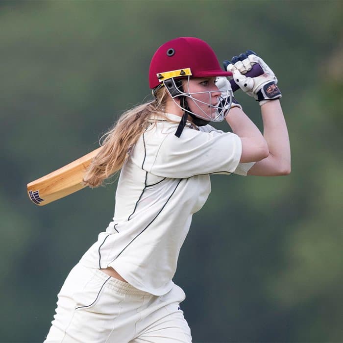 female cricketer batting