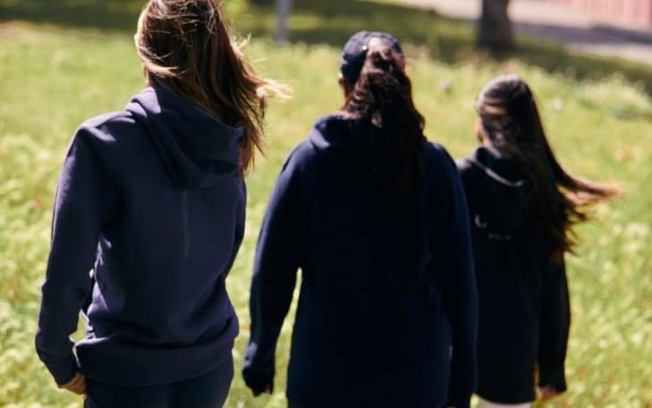 girls in navy cricket hoodies
